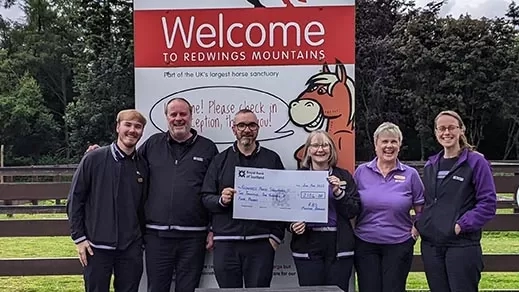 Members of RBS present a cheque at Redwings Mountains.