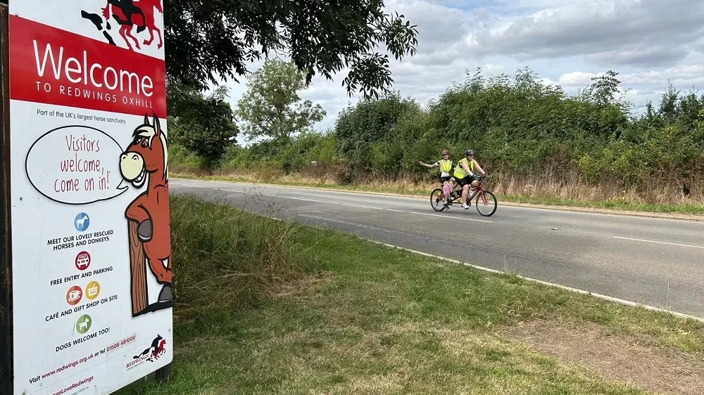 Izzy and team member on the tandem