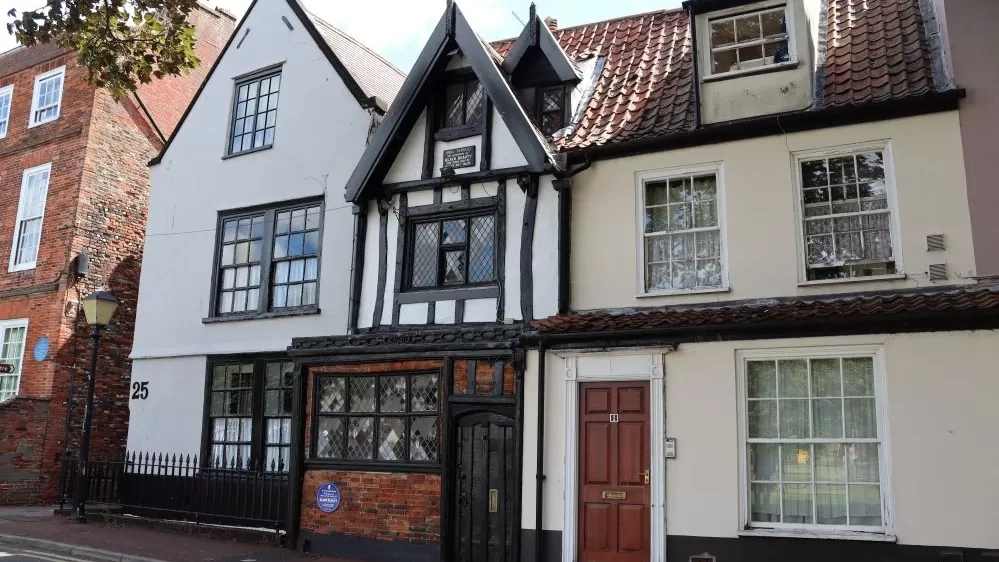 A terrace of old buildings with a small three-storey home in the middle with Tudor-like beams which was the former home of Anna Sewell.