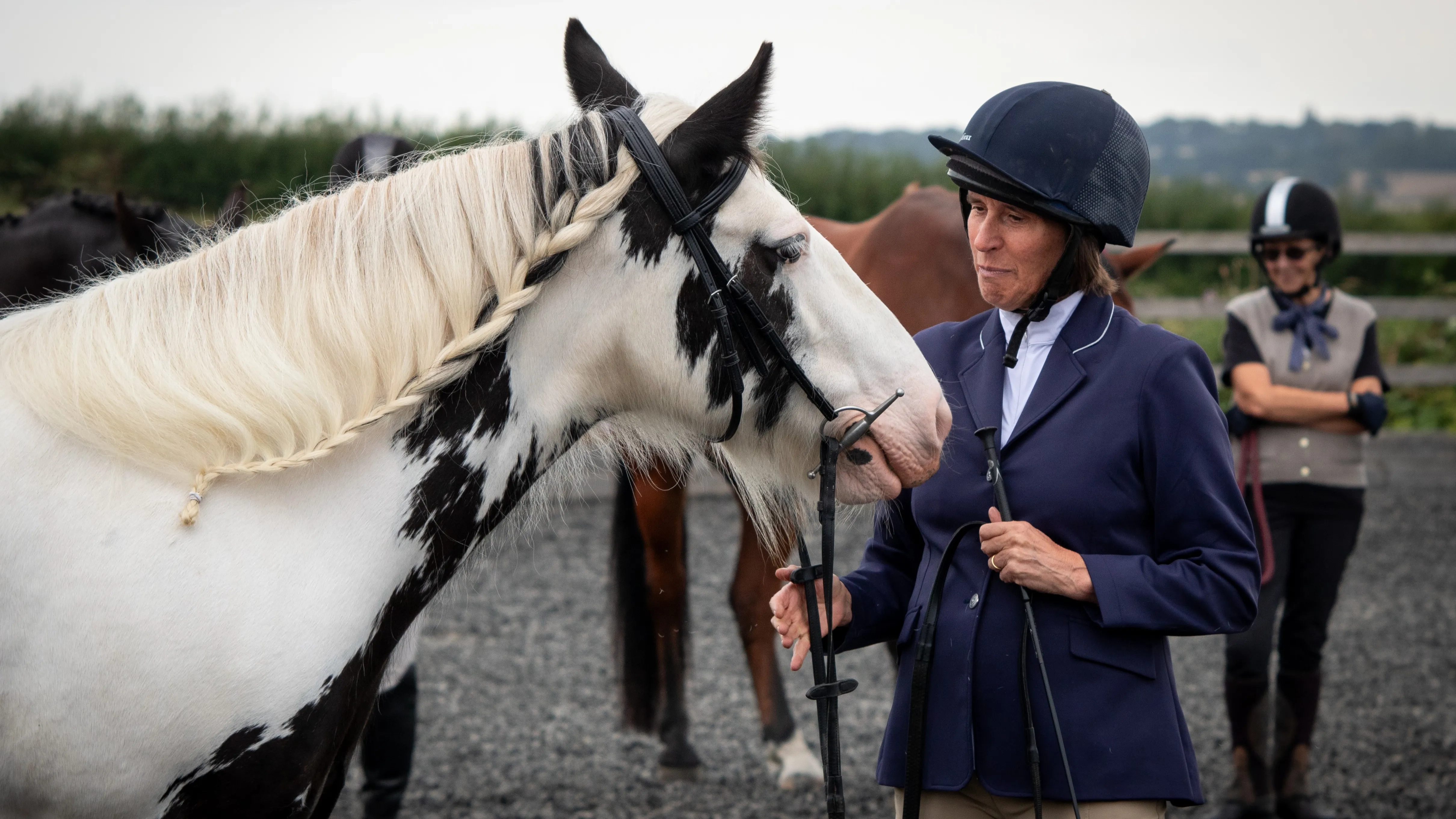 Photo of Sue stood with her rehomed Redwings horse Estelle before a show.