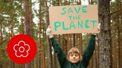 Person holding  a save the planet banner