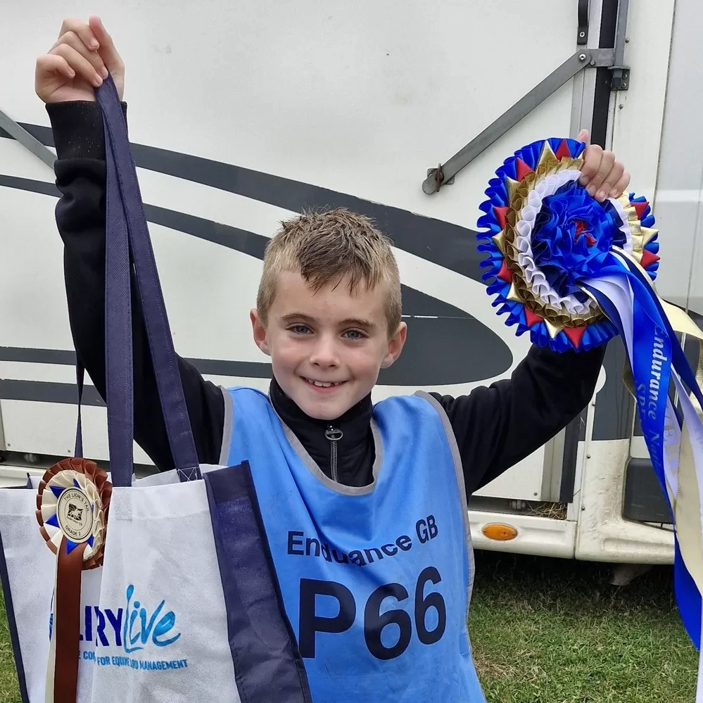 Alfie-Jay with his rosettes and prizes