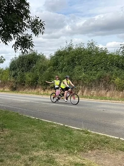 Izzy and team member on the tandem