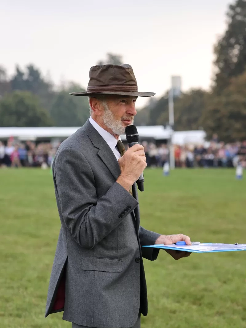 Trustee Ian is stood in an equestrian showing ring commentating 